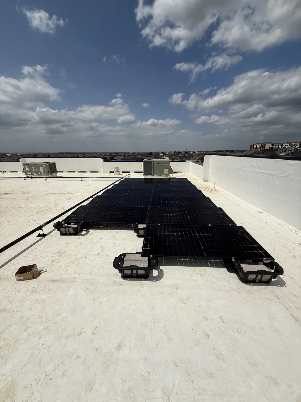 Solar panels on mounting supports across a flat roof