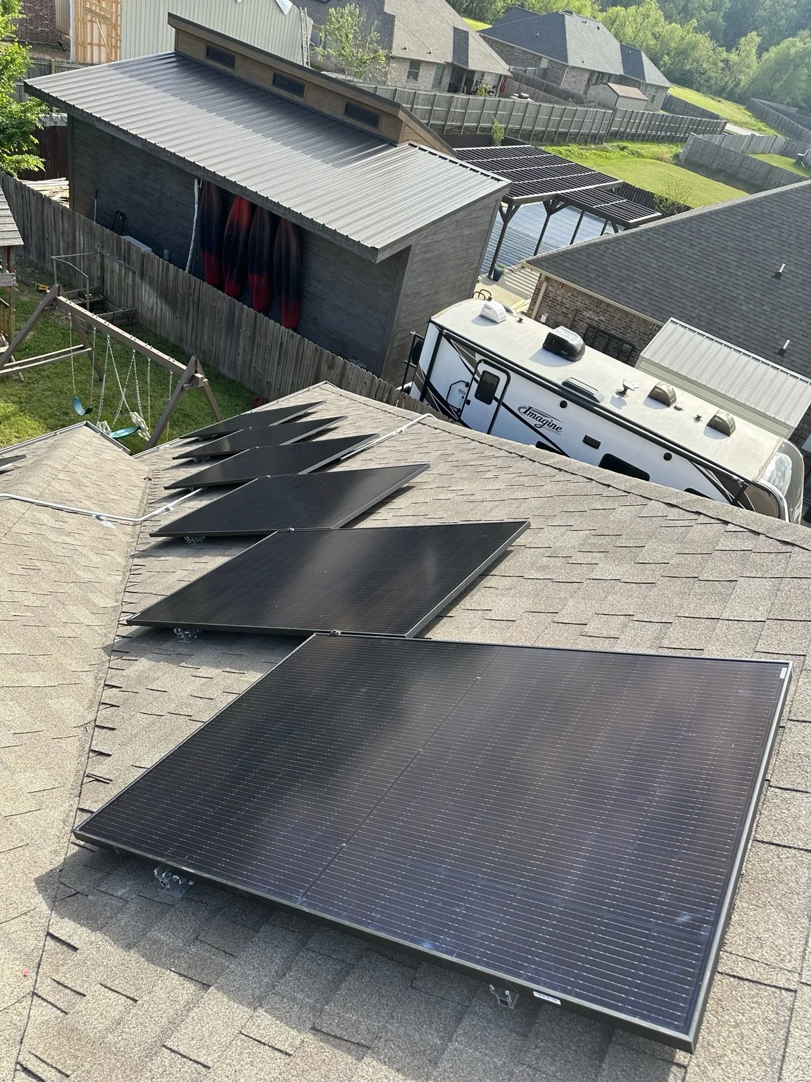 Rooftop solar panels photographed from above the roof edge