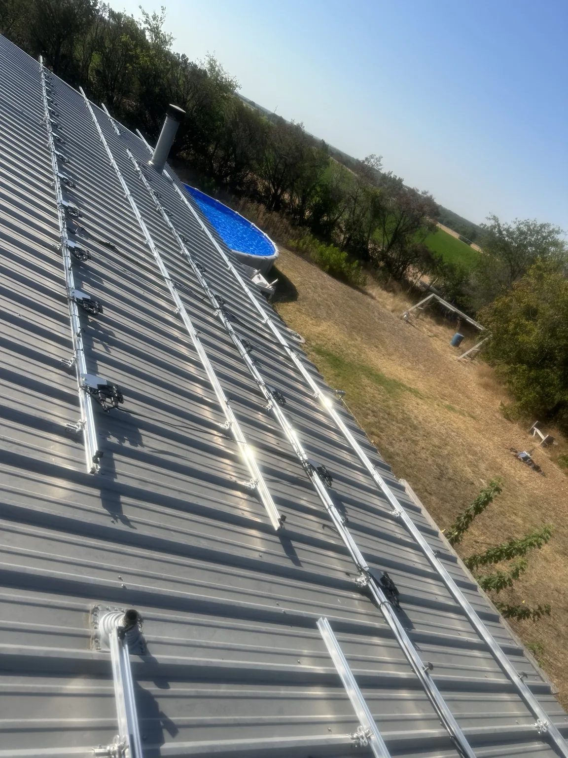 Solar mounting rails across a metal roof