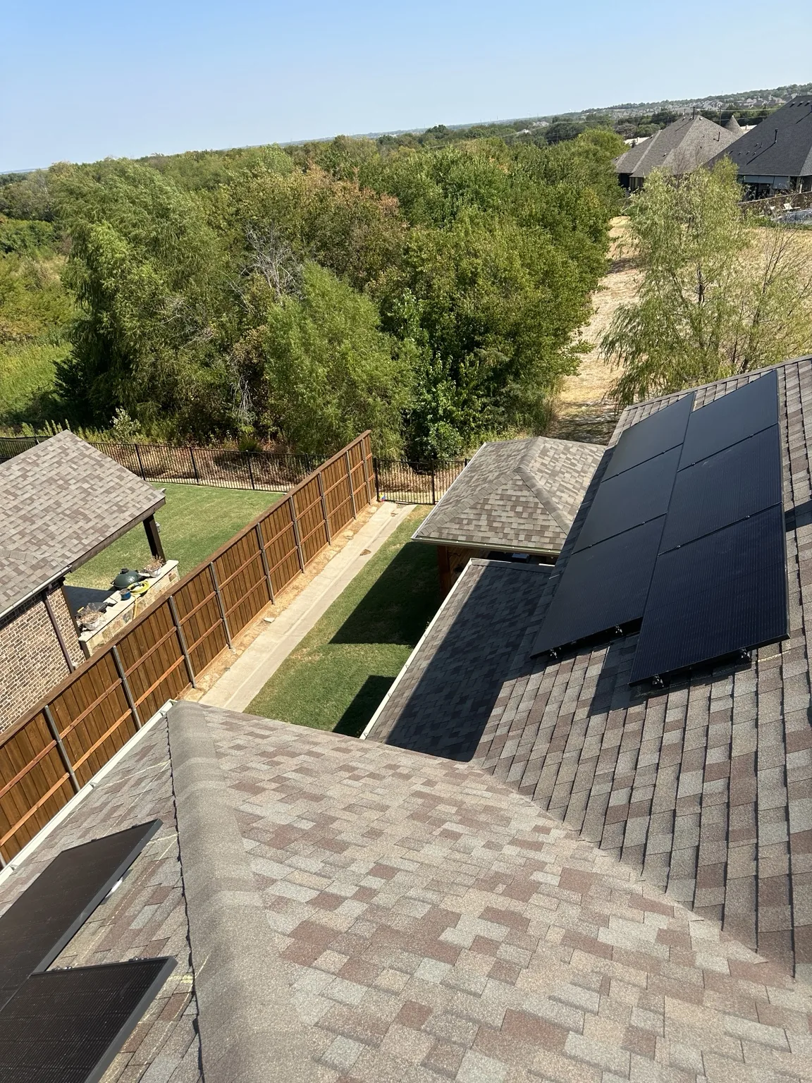 Solar panels arranged across a residential shingle roof