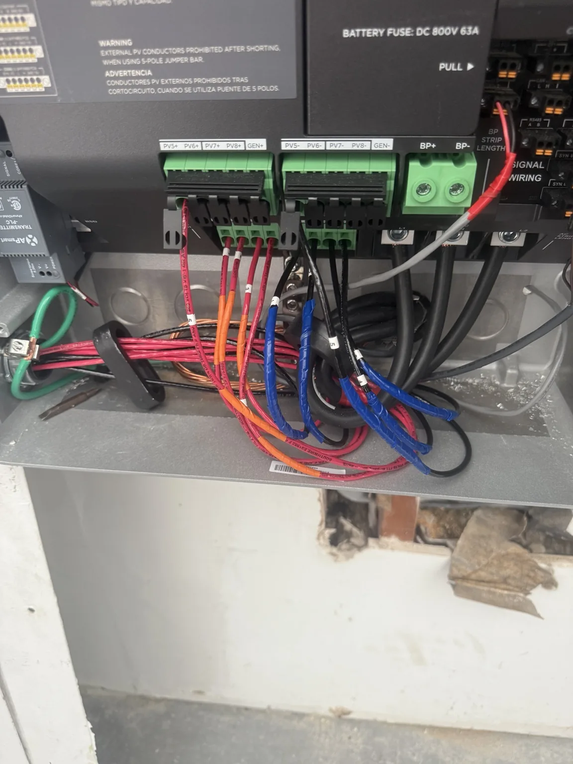 Wiring and labeled connection terminals inside solar equipment