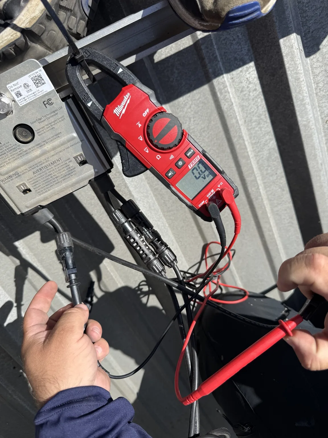 Meter probes used to check rooftop solar optimizer connections